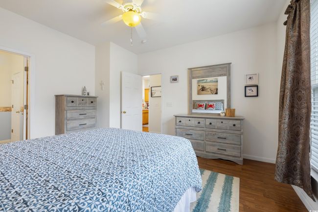 Bedroom featuring wood finished floors, baseboards, and a ceiling fan | Image 19