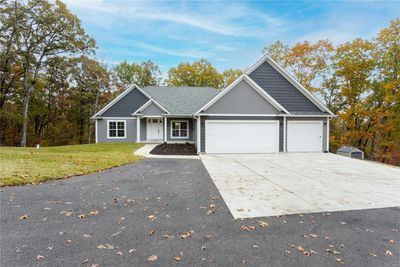 View of front of house featuring a front lawn and a garage | Image 2