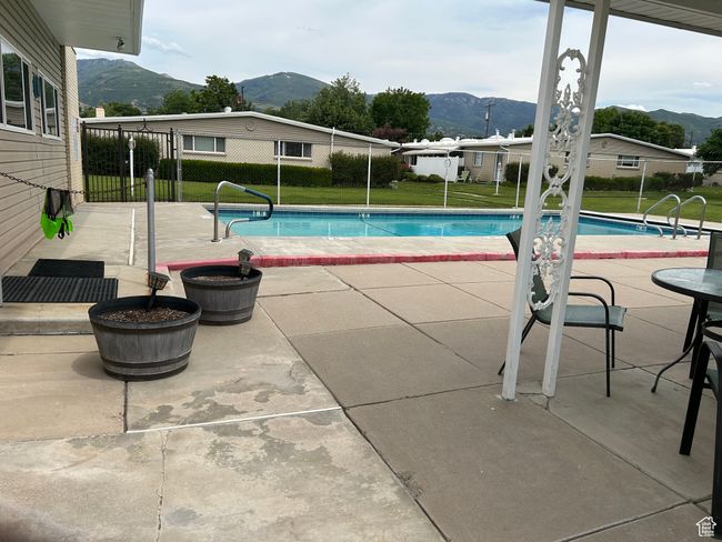 View of pool with a mountain view and a patio area | Image 17