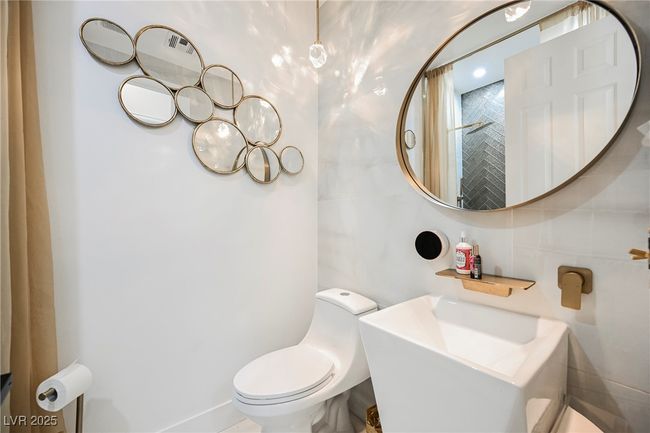 Downstairs 3/4 Bathroom featuring toilet and tile walls | Image 27