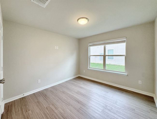 Empty room with wood finished floors and baseboards | Image 12