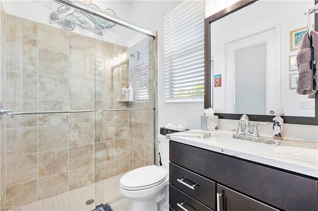 Full bathroom featuring vanity, toilet, and a stall shower | Image 44