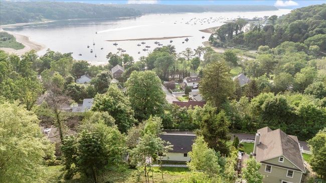 Drone / aerial view of a nearby body of water and a heavily wooded area | Image 38