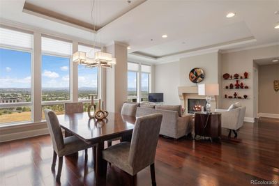 The open-concept design seamlessly connects the dining room to the living room, creating a spacious and airy flow with large windows offering stunning views. | Image 2