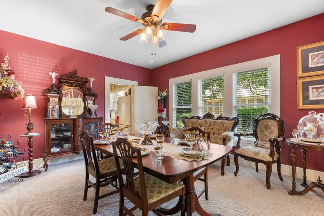 Dining area featuring light colored carpet and a ceiling fan | Image 11