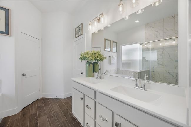 Crisp lines and a generous countertop make this vanity area both functional and beautiful, with sleek finishes that enhance the space’s fresh, modern look. | Image 20