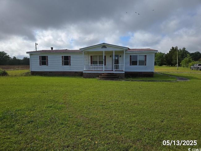 View of front of house featuring a porch, crawl space, and a front lawn | Image 8