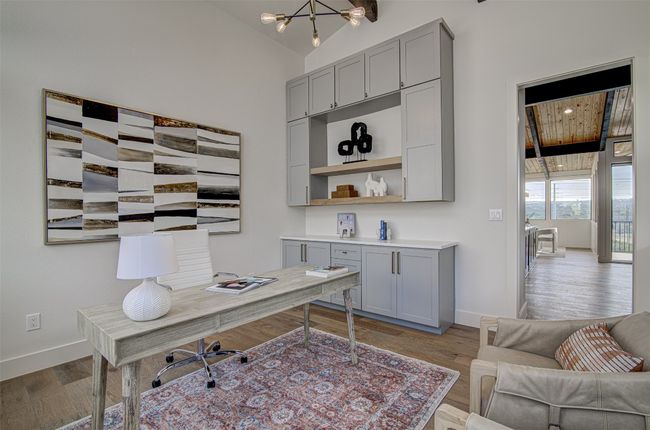 Home office with baseboards, wood finished floors, and vaulted ceiling | Image 7