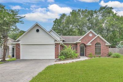 Welcome to your dream home nestled in the prestigious April Sound Country Club Community, where luxury living meets serene surroundings. This stunning 3+ bedroom, 2 bathroom, residence with a spacious 2 car garage epitomizes refined elegance and modern comfort. | Image 1