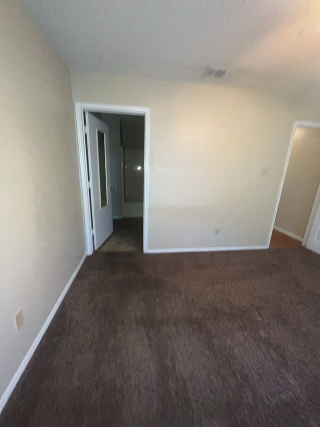 Spare room featuring carpet, baseboards, and visible vents | Image 8