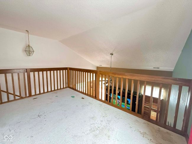 additional living space featuring vaulted ceiling, a textured ceiling, and carpet floors | Image 19
