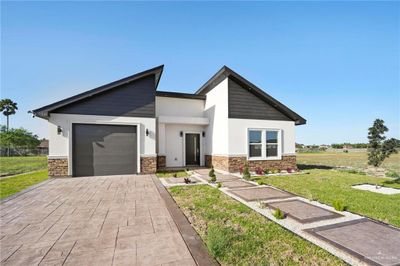 View of front of home with a front yard and a garage | Image 2