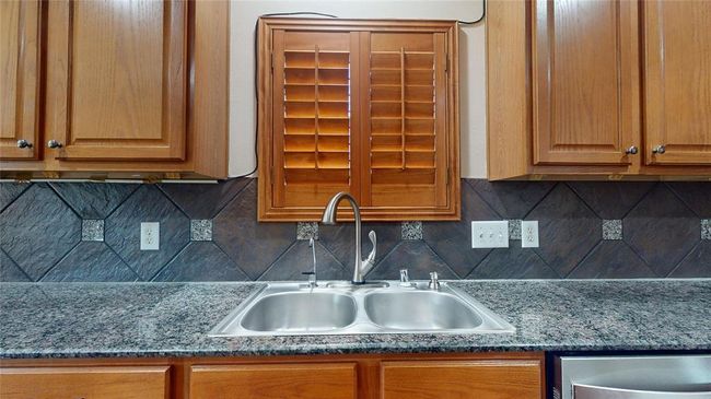 Elegant gourmet kitchen featuring a double sink with a picturesque window view. | Image 16