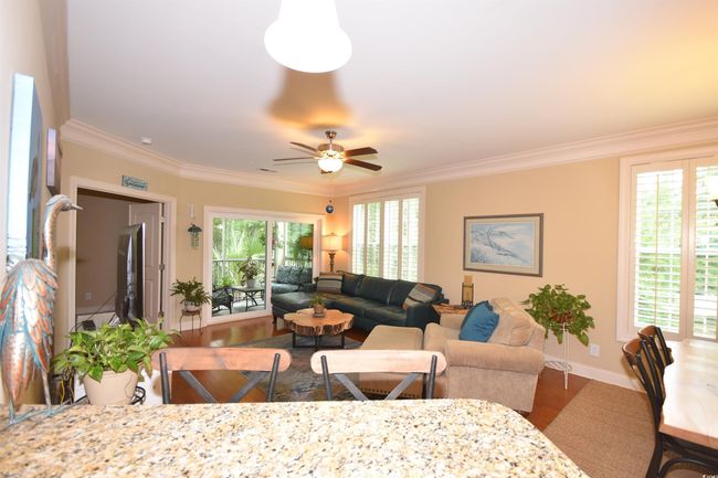 Living room featuring crown molding, ceiling fan, and wood finished floors | Image 11