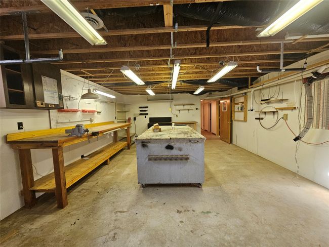 The woodworking area has a large table that has rollers so you can move it to more convenient location for your work. | Image 33