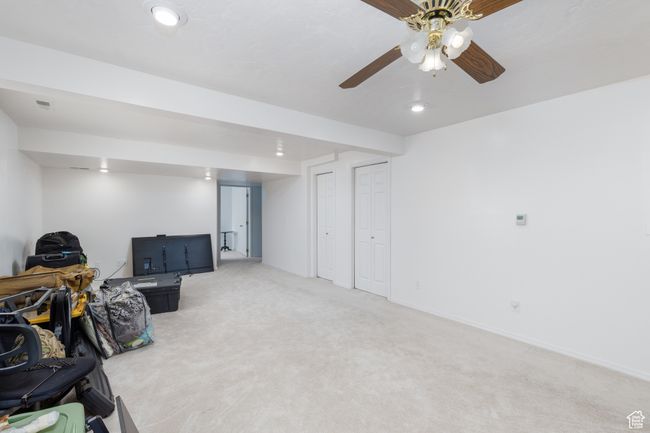 Finished basement with light colored carpet, recessed lighting, and a ceiling fan | Image 16