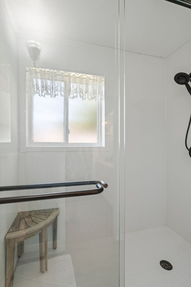 Bathroom featuring a stall shower and healthy amount of natural light | Image 31