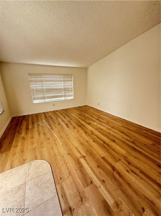 Spare room with hardwood / wood-style floors and a textured ceiling | Image 25