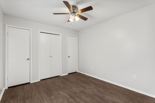 Back bedroom features two closets and ceiling fan | Image 17
