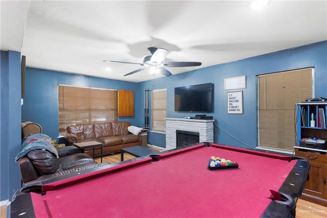 Rec room with billiards table, ceiling fan, a fireplace, wood finished floors, and recessed lighting | Image 4