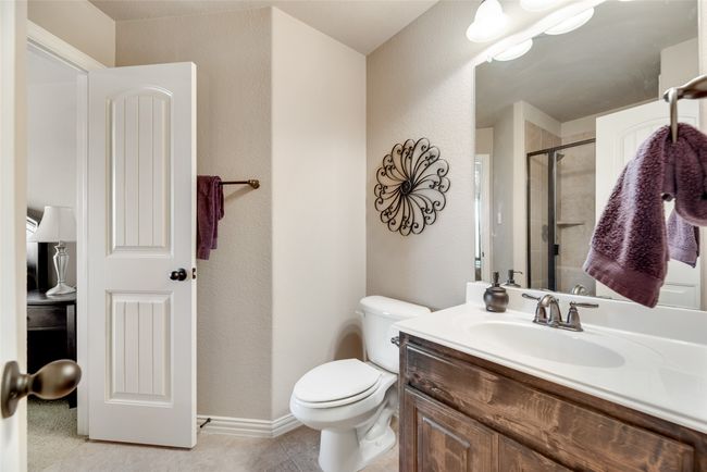 Bathroom featuring vanity, a shower stall, and a textured wall | Image 24