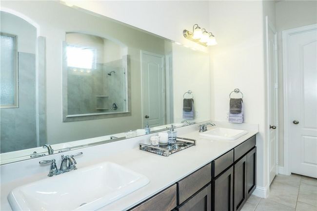 Full bathroom with double vanity and tile patterned flooring | Image 17
