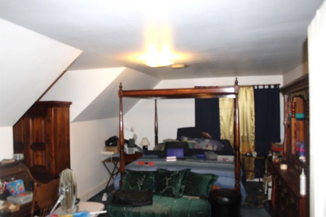 Bedroom featuring lofted ceiling | Image 17
