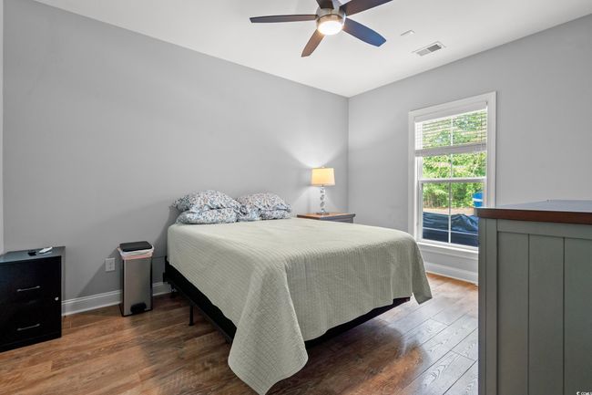 Bedroom with wood finished floors and ceiling fan | Image 15