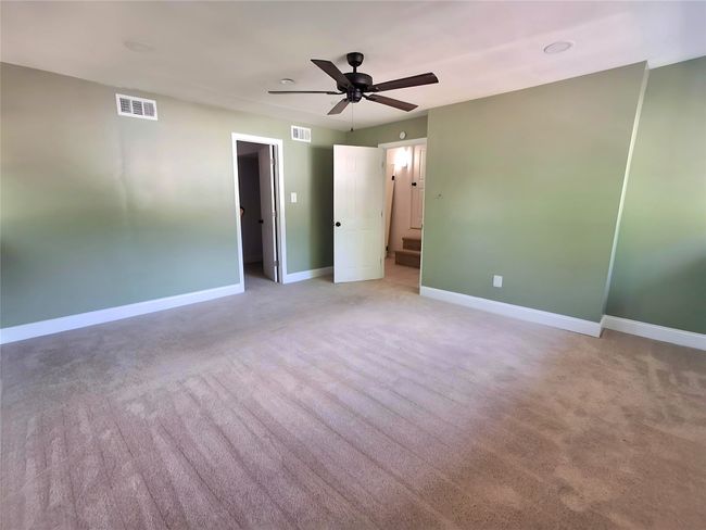 Unfurnished bedroom with baseboards, carpet floors, and ceiling fan | Image 24
