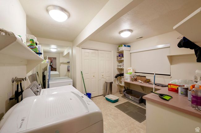 Washroom featuring laundry area, visible vents, and washing machine and dryer | Image 36