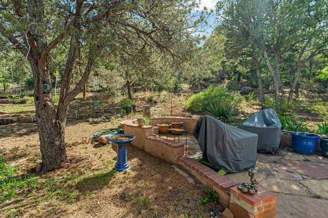 Fully fenced back yard with stone patio | Image 39