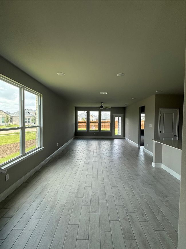 Empty room with wood finished floors, recessed lighting, and ceiling fan | Image 5