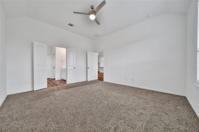The primary suite is spacious and has high ceilings and an upgraded ceiling fan.. | Image 27