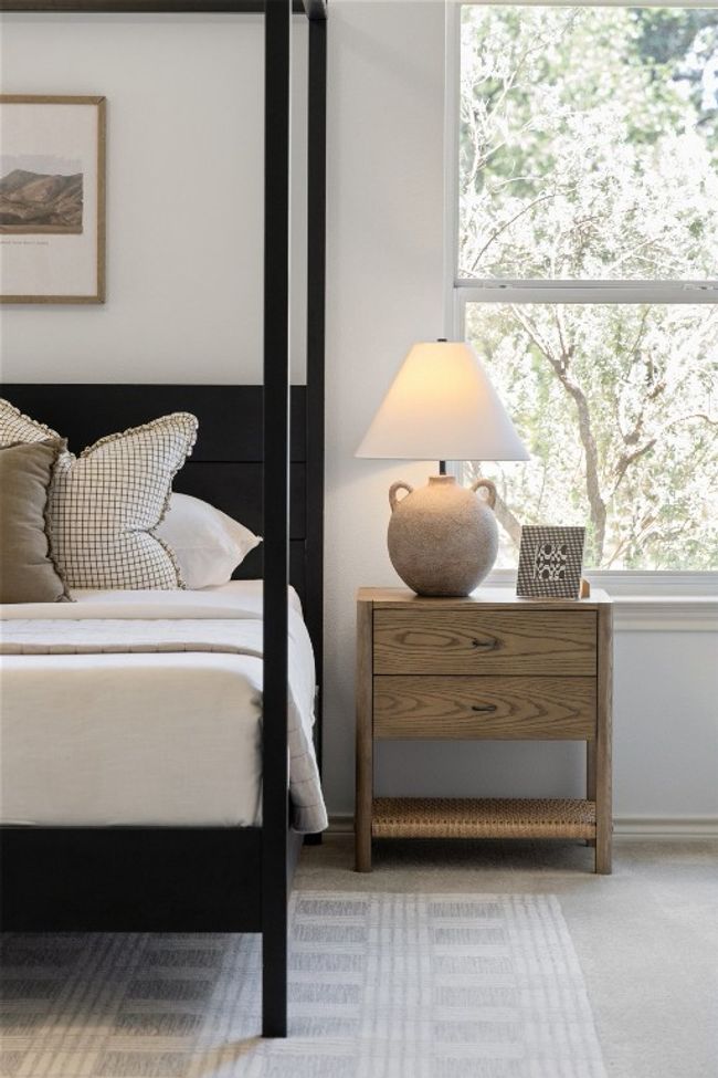 Abundant natural light flows through the primary bedroom windows. | Image 16