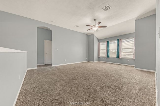 Carpeted spare room with vaulted ceiling and ceiling fan | Image 15