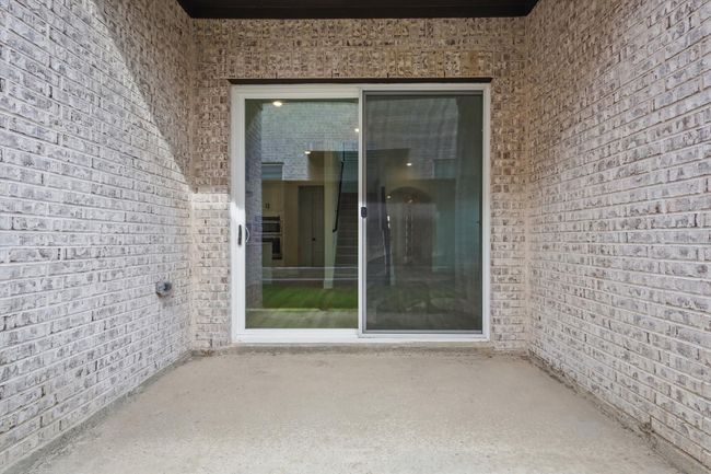Doorway to property featuring brick siding and a patio | Image 33