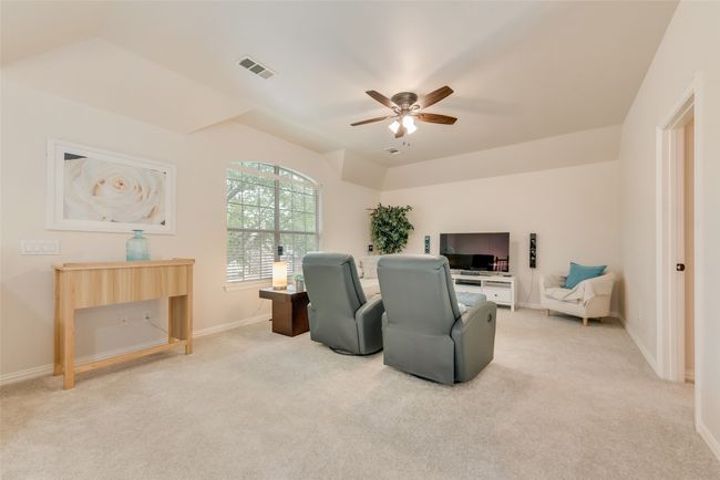 Living area with carpet floors, ceiling fan, and baseboards | Image 22