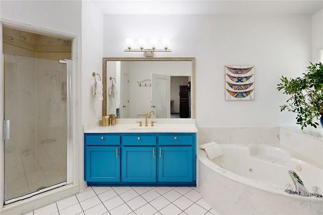 Bathroom with vanity, tile patterned flooring, a whirlpool tub, and a stall shower | Image 17