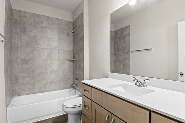 Full bathroom featuring toilet, shower combination, vanity, and wood finished floors | Image 20
