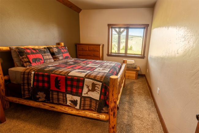 Carpeted bedroom featuring a textured wall and baseboards | Image 23