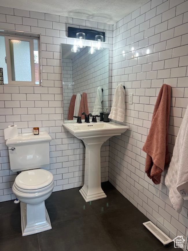 Bathroom featuring tile walls, tile patterned floors, and sink | Image 18
