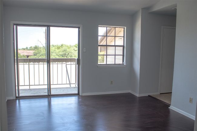 Spare room featuring dark wood finished floors and baseboards | Image 15