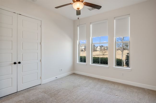 Unfurnished bedroom featuring carpet floors, a closet, and ceiling fan | Image 7