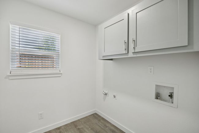 The perfect laundry room is nestled between the kitchen and the garage - even has extra storage! | Image 34