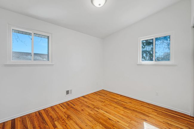 Unfurnished bedroom with a closet, baseboards, and light wood-style floors | Image 12