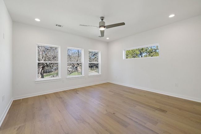 Unfurnished room featuring baseboards, wood finished floors, visible vents, and recessed lighting | Image 22