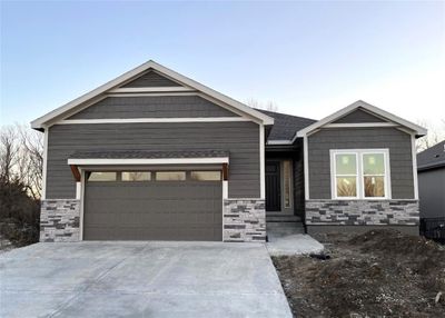 View of front of house featuring a front yard and a garage | Image 1