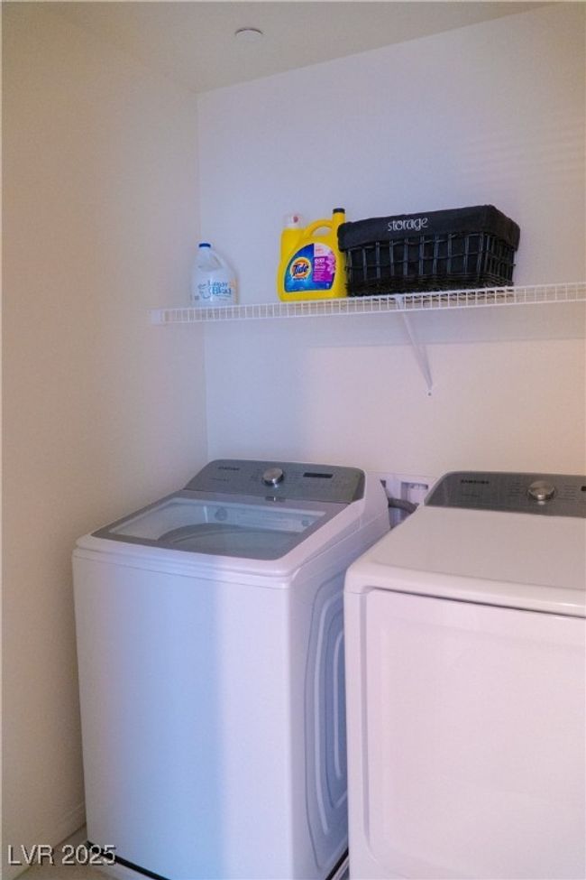 Laundry room featuring washing machine and clothes dryer and laundry area | Image 38