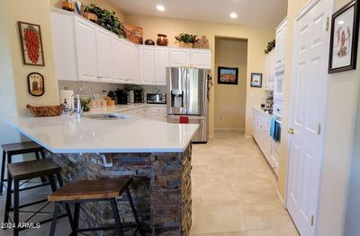 Updated kitchen with quartz counters, stacked stone, gas cooktop & wall oven! | Image 3