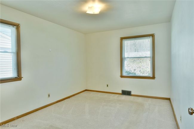 Empty room featuring carpet floors, visible vents, and baseboards | Image 21